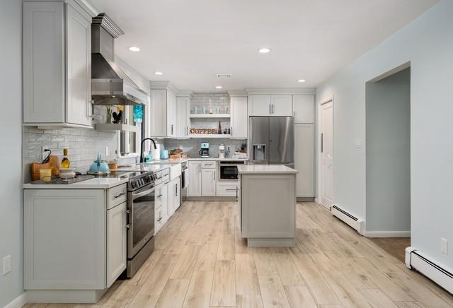 6 Circle Dr, Shoreham, NY 11786 - kitchen with appliances with stainless steel finishes, range hood, baseboard heating, open shelves, and backsplash