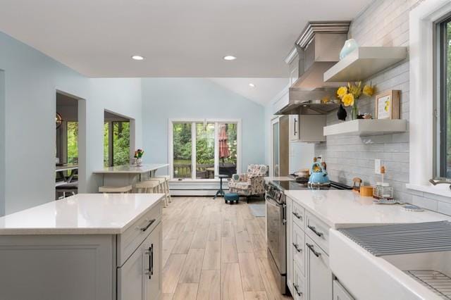 6 Circle Dr, Shoreham, NY 11786 - kitchen featuring stainless steel electric range oven, plenty of natural light, light countertops, light wood-style flooring, and vaulted ceiling