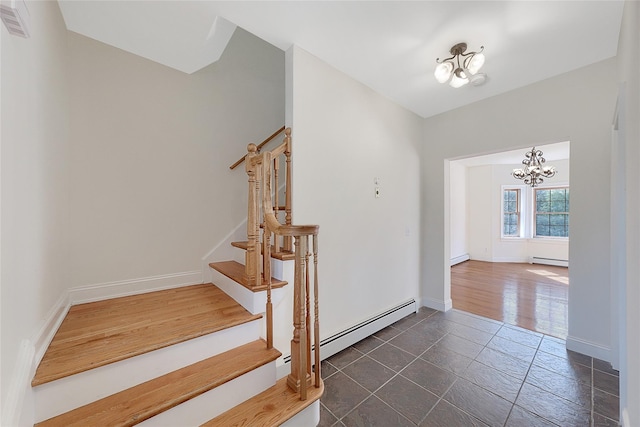 stairs featuring baseboards, visible vents, a chandelier, and baseboard heating