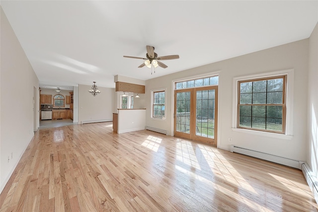 unfurnished living room with baseboards, baseboard heating, light wood finished floors, and ceiling fan with notable chandelier