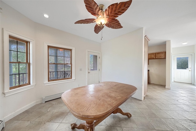 dining space with a baseboard radiator, ceiling fan, baseboard heating, and a wealth of natural light