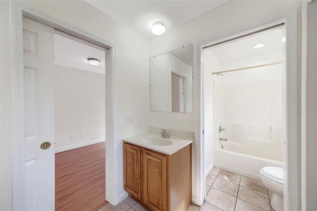 bathroom featuring vanity, tile patterned floors, bathtub / shower combination, and toilet