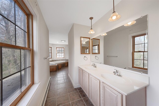 bathroom featuring a sink, baseboards, double vanity, and a bath