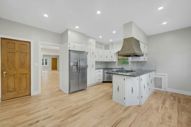 39 Crestmont Ave, Yonkers, NY 10704 - kitchen featuring stainless steel appliances, a peninsula, white cabinetry, dark countertops, and light wood-style flooring