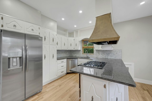 39 Crestmont Ave, Yonkers, NY 10704 - kitchen with appliances with stainless steel finishes, island range hood, a sink, a peninsula, and white cabinets