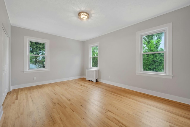 39 Crestmont Ave, Yonkers, NY 10704 - spare room featuring radiator, light wood-style flooring, and baseboards