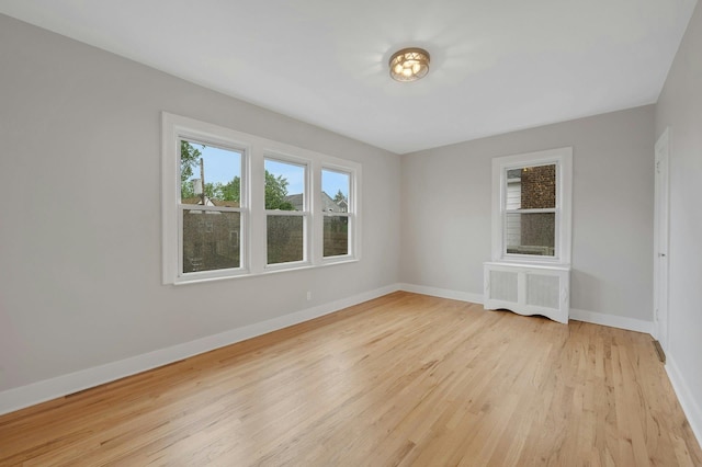 39 Crestmont Ave, Yonkers, NY 10704 - empty room featuring radiator heating unit, light wood-type flooring, and baseboards