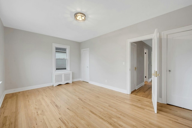 39 Crestmont Ave, Yonkers, NY 10704 - unfurnished room featuring radiator heating unit, light wood-type flooring, and baseboards
