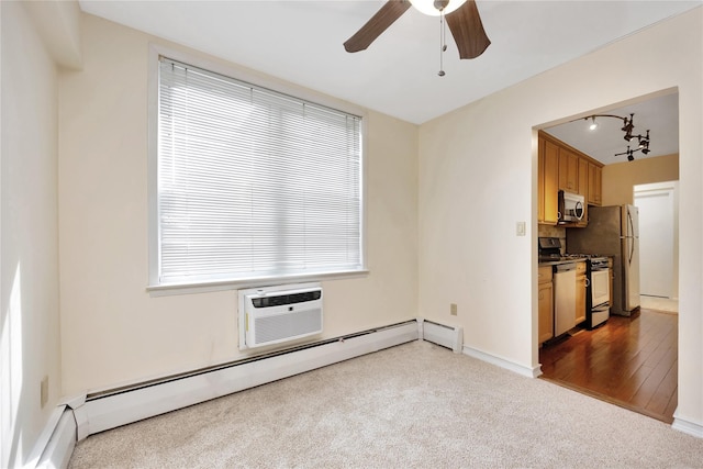 40 Daley Pl Unit 230, Lynbrook, NY 11563 - unfurnished living room with carpet floors, a baseboard radiator, a ceiling fan, a wall mounted air conditioner, and baseboards