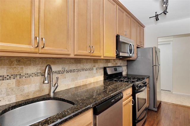 40 Daley Pl Unit 230, Lynbrook, NY 11563 - kitchen with appliances with stainless steel finishes, a sink, dark stone countertops, dark wood-style flooring, and tasteful backsplash