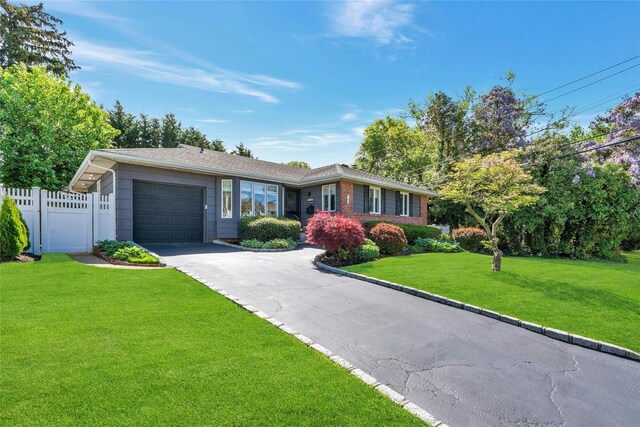 single story home with a garage and driveway