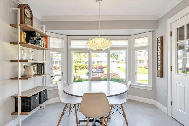 dining space featuring baseboards, ornamental molding, and light tile patterned flooring