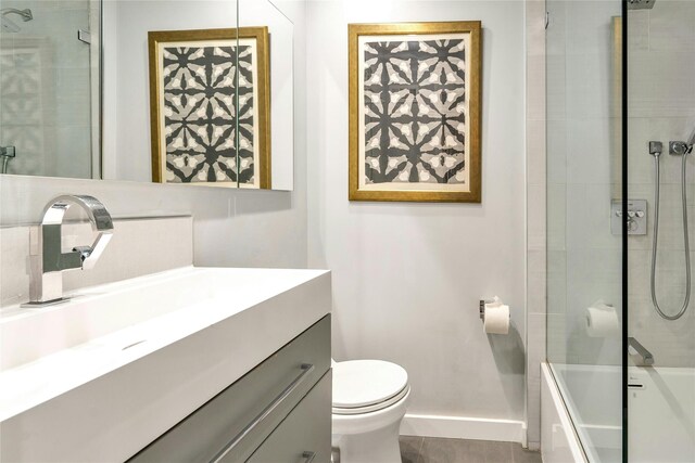 full bath featuring baseboards, toilet, vanity, and shower / tub combination