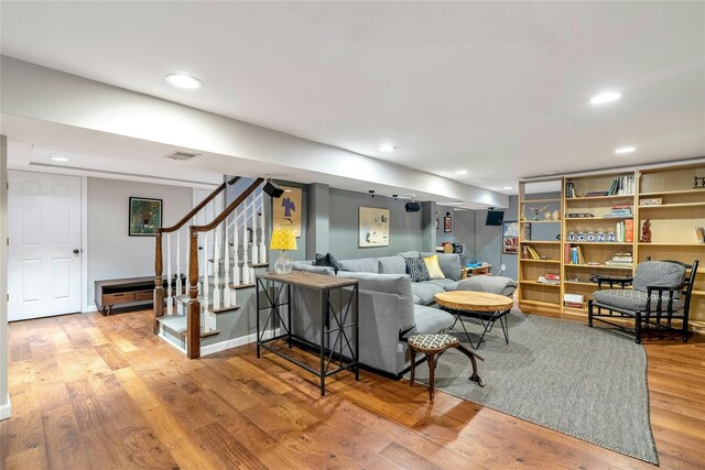 living area with stairway, wood finished floors, and recessed lighting
