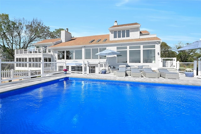 outdoor pool featuring an outdoor living space, a patio, a sunroom, and fence