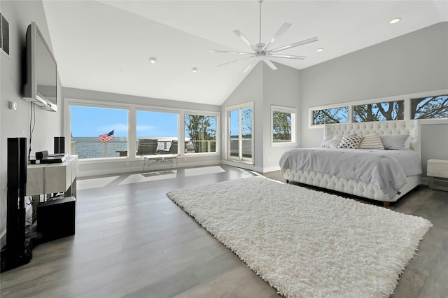 bedroom featuring a ceiling fan, recessed lighting, baseboards, high vaulted ceiling, and wood finished floors