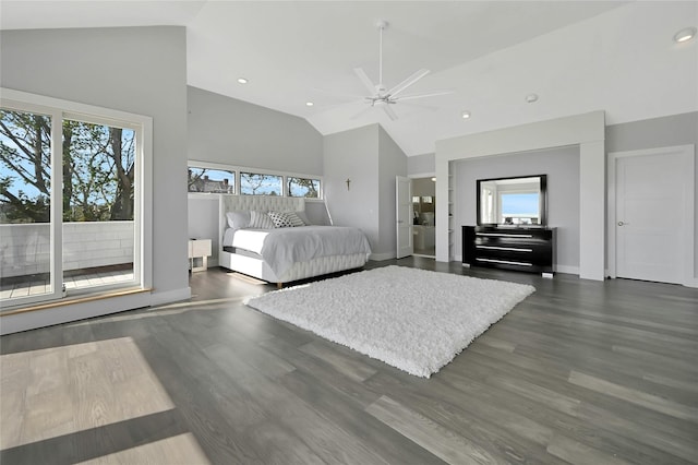 bedroom featuring multiple windows, baseboards, and high vaulted ceiling