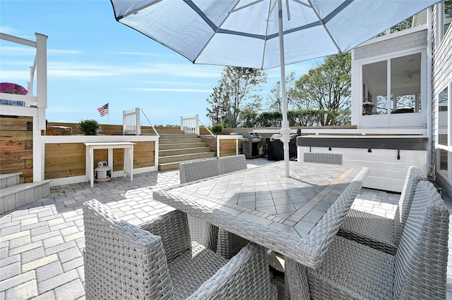 view of patio featuring grilling area, outdoor dining space, and stairs
