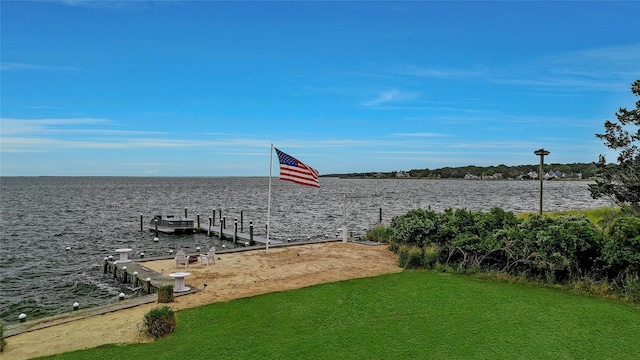 dock area featuring a water view and a lawn