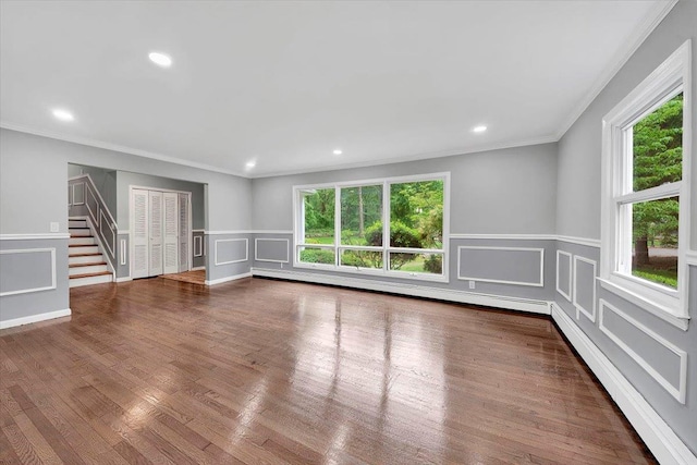 83 Sherwood Rd, Cortlandt Manor, NY 10567 - empty room featuring healthy amount of natural light, a decorative wall, stairs, crown molding, and recessed lighting