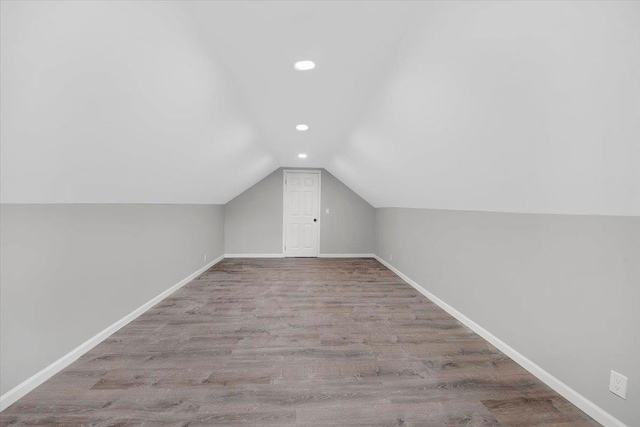 83 Sherwood Rd, Cortlandt Manor, NY 10567 - additional living space with wood finished floors, recessed lighting, vaulted ceiling, and baseboards