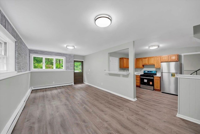 83 Sherwood Rd, Cortlandt Manor, NY 10567 - unfurnished living room with a baseboard heating unit, light wood-style flooring, and baseboards