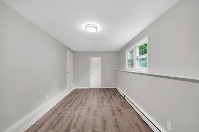 83 Sherwood Rd, Cortlandt Manor, NY 10567 - spare room featuring a baseboard heating unit, wood finished floors, and baseboards