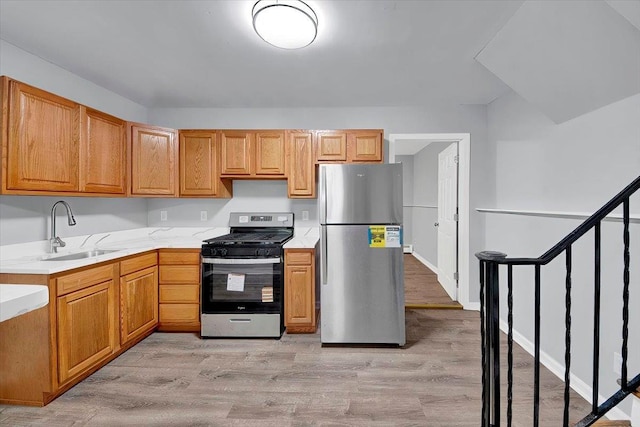 83 Sherwood Rd, Cortlandt Manor, NY 10567 - kitchen with stainless steel appliances, a sink, and light wood finished floors