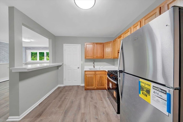 83 Sherwood Rd, Cortlandt Manor, NY 10567 - kitchen featuring freestanding refrigerator, range with gas cooktop, light countertops, light wood finished floors, and a sink