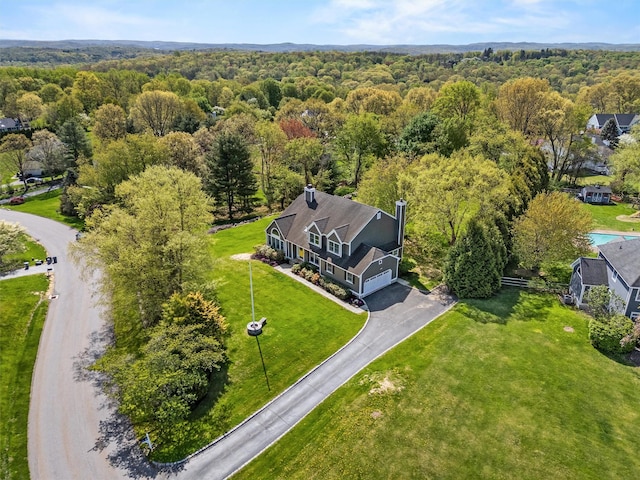 aerial view featuring a wooded view