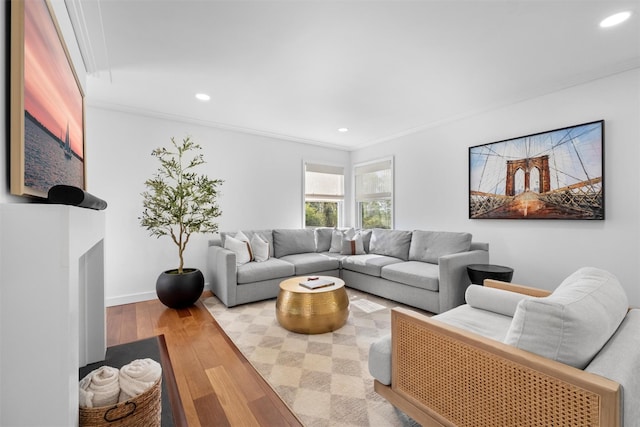 living area with crown molding, wood finished floors, and recessed lighting
