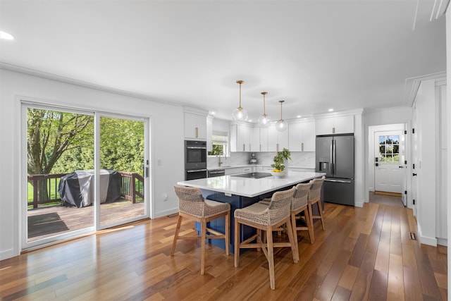 dining space with light wood finished floors, crown molding, baseboards, and recessed lighting