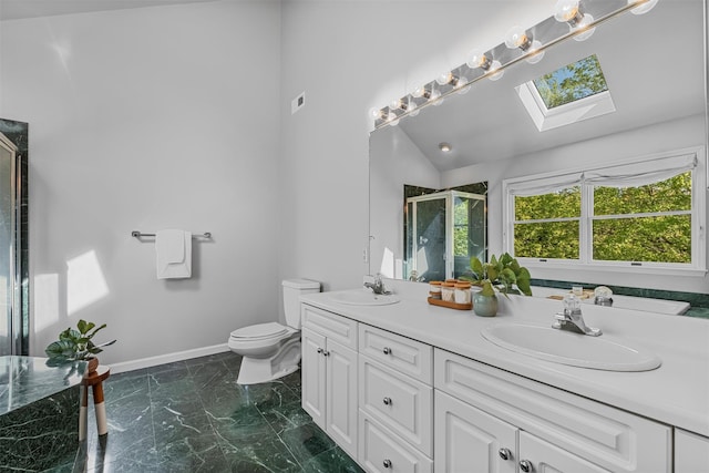 bathroom with a sink, toilet, baseboards, and a shower stall