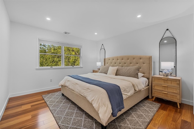 bedroom with recessed lighting, visible vents, and wood finished floors