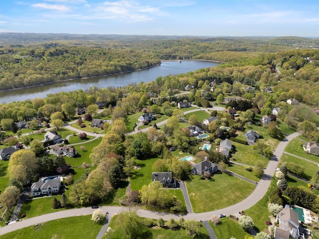 bird's eye view with a wooded view, a water view, and a residential view