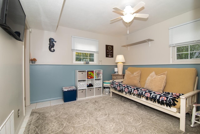 living area featuring plenty of natural light, a ceiling fan, and tile patterned floors