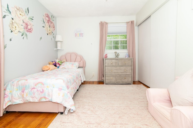 bedroom featuring wood finished floors and a closet