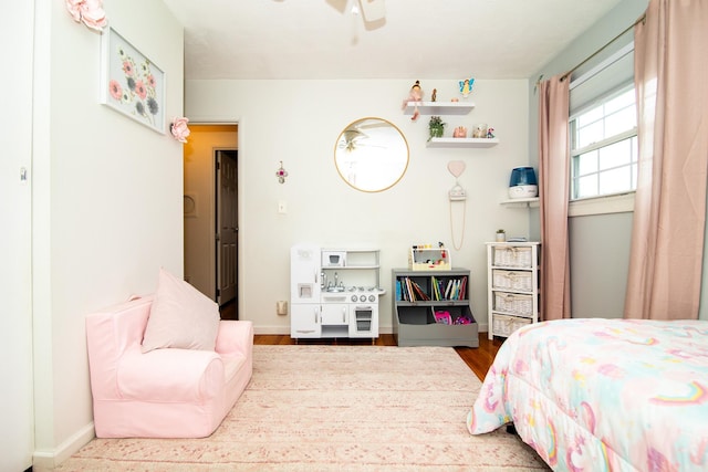 bedroom with wood finished floors and baseboards