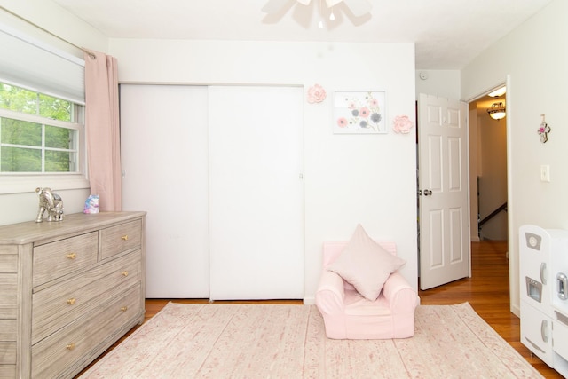 bedroom featuring wood finished floors, a closet, and ceiling fan