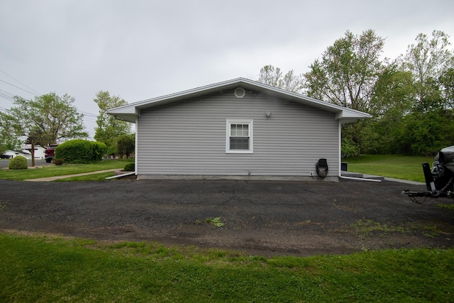view of property exterior featuring a lawn