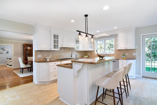 668 Francis St, Pelham, NY 10803 - kitchen with a breakfast bar, a sink, custom range hood, open shelves, and dark stone countertops