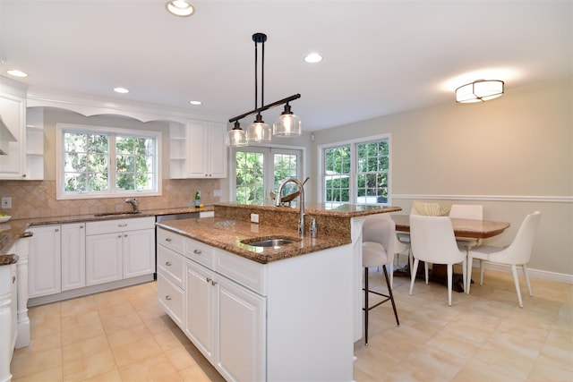 668 Francis St, Pelham, NY 10803 - kitchen featuring open shelves, white cabinets, a kitchen breakfast bar, and a sink