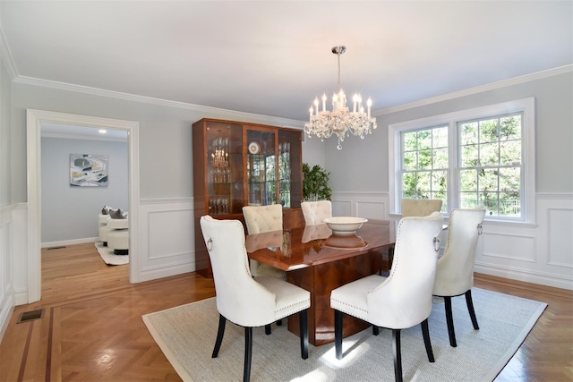 668 Francis St, Pelham, NY 10803 - dining space featuring ornamental molding, a wainscoted wall, a chandelier, and a decorative wall
