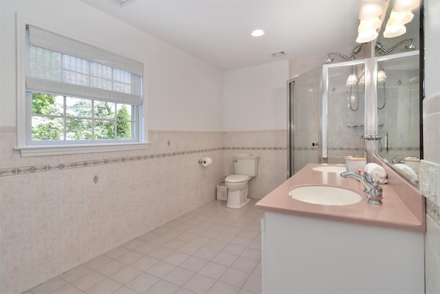 668 Francis St, Pelham, NY 10803 - full bath with tile patterned flooring, tile walls, double vanity, a shower stall, and a wainscoted wall