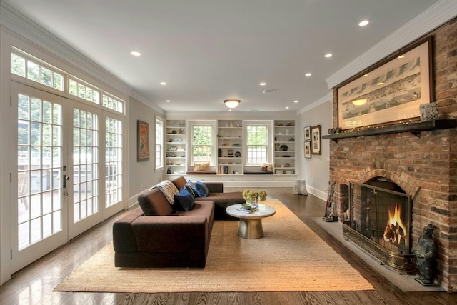 living room with a fireplace, built in shelves, wood finished floors, recessed lighting, and ornamental molding