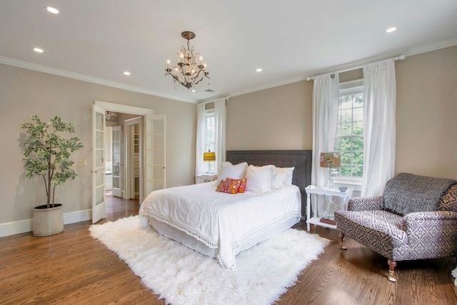 bedroom with wood finished floors, a chandelier, recessed lighting, ornamental molding, and baseboards