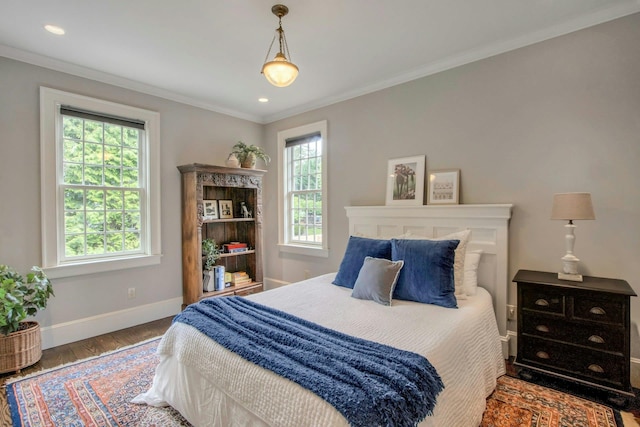 bedroom with baseboards, wood finished floors, ornamental molding, and recessed lighting