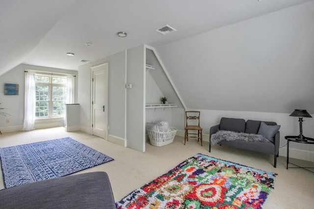 carpeted bedroom with vaulted ceiling and baseboards