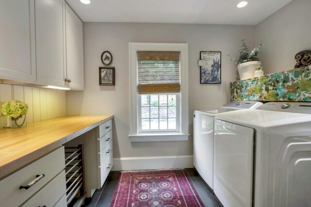 clothes washing area with cabinet space, washing machine and dryer, dark tile patterned floors, baseboards, and recessed lighting