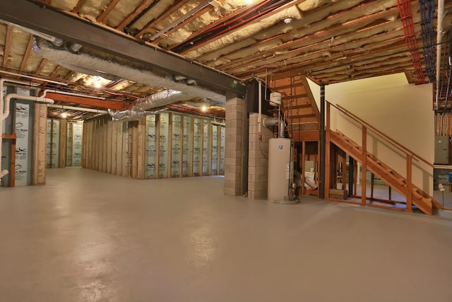 unfinished below grade area featuring gas water heater and electric panel
